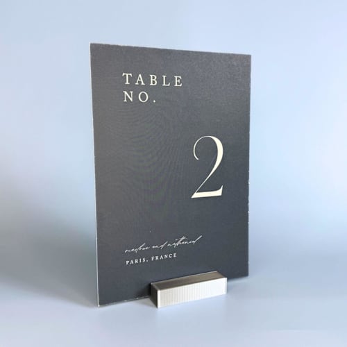 This is a silver place card holders by Corduroy Effect called silver color rectangle table number holder, set of 5 in standard