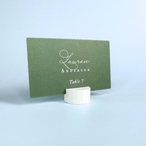 This is a white place card holders by Corduroy Effect called white circle place card holder, set of 25 in standard