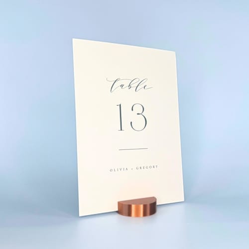 This is a copper place card holders by Corduroy Effect called copper color round table number holder, set of 5 in standard