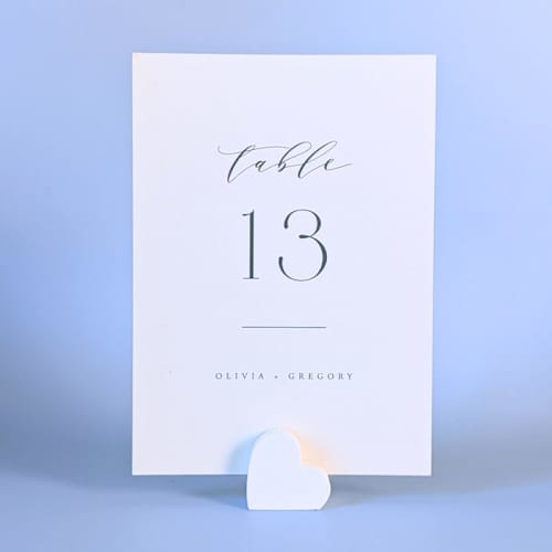 This is a white place card holders by Corduroy Effect called white heart table number holders, set of 5 in standard