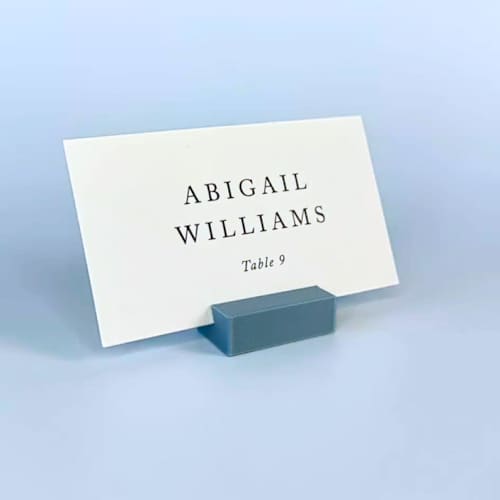 This is a blue place card holders by Corduroy Effect called dusty blue rectangle place card holder, set of 25 in standard