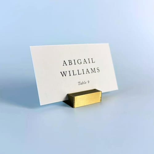 This is a brass place card holders by Corduroy Effect called brass color rectangle place card holder, set of 25 in standard