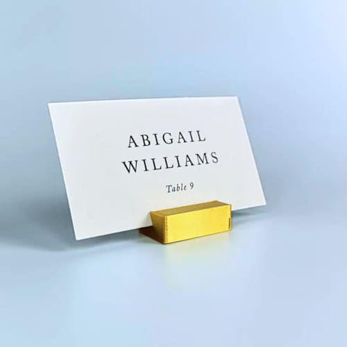 This is a gold place card holders by Corduroy Effect called gold color rectangle place card holder, set of 25 in standard