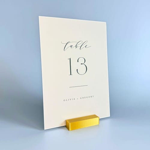 This is a gold place card holders by Corduroy Effect called gold color rectangle table number holder, set of 5 in standard