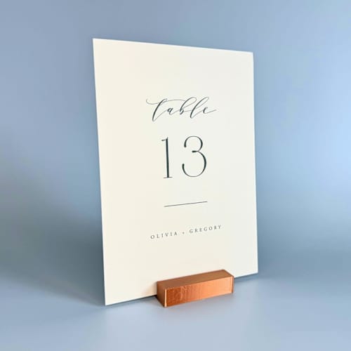 This is a copper place card holders by Corduroy Effect called copper color rectangle table number holder, set of 5 in standard