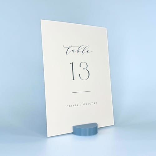 This is a blue place card holders by Corduroy Effect called dusty blue round table number holder, set of 5 in standard