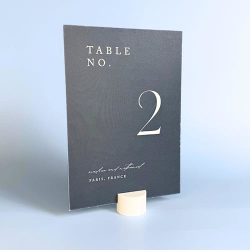 This is a white place card holders by Corduroy Effect called white circle table number holder, set of 5 in standard