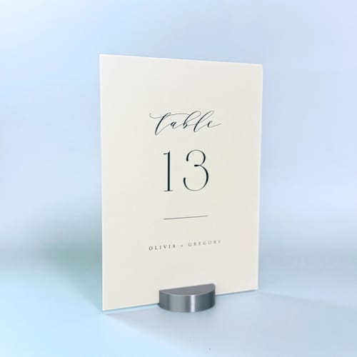 This is a silver place card holders by Corduroy Effect called silver color round table number holder, set of 5 in standard