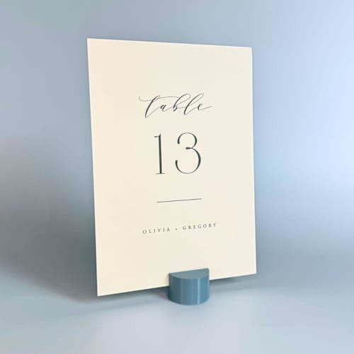 This is a blue place card holders by Corduroy Effect called dusty blue circle table number holder, set of 5 in standard