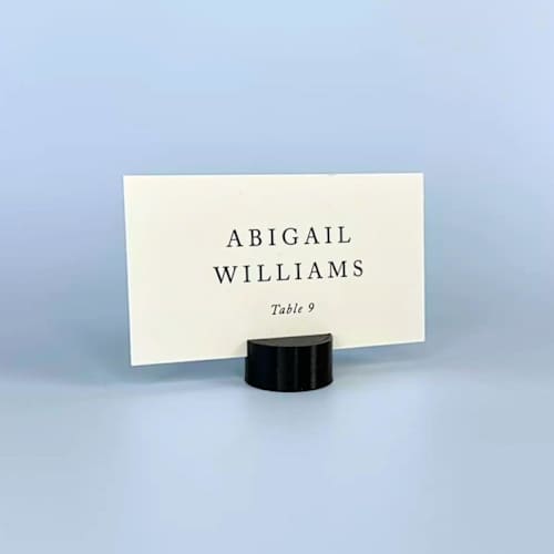 This is a black place card holders by Corduroy Effect called black circle place card holder, set of 25 in standard