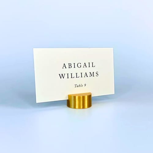 This is a gold place card holders by Corduroy Effect called gold color circle place card holder, set of 25 in standard