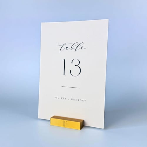 This is a gold place card holders by Corduroy Effect called personalized gold color rectangle table number holders, set of 5 in standard