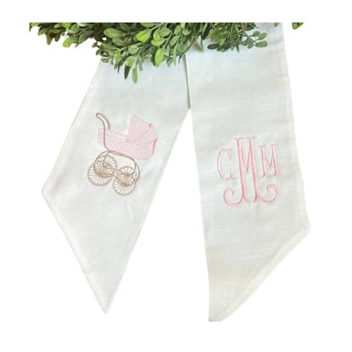 This is a white holiday decorations by Virginia Marcello called custom embroidered baby carriage wreath sash with monogram in standard