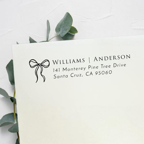 This is a black address labels by Samantha Malvey called wavy bow stamp | self inking return address stamp in standard