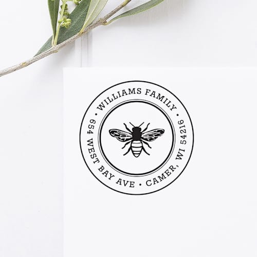 This is a black address labels by Port of Reverie called honey bee return address stamp, round self inking in standard