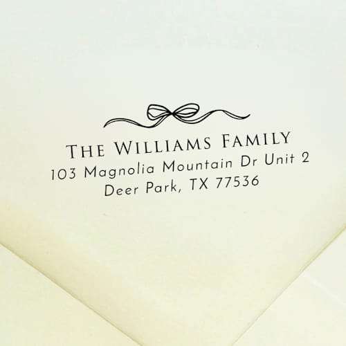 This is a black address labels by Samantha Malvey called elegant bow address stamp | self inking return address stamp in standard