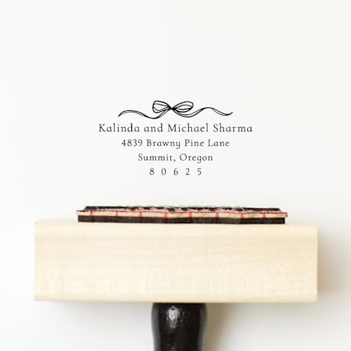 This is a multicolorassorted-colors address labels by Sara Luke called coquette bow address stamp | wood handle stamp in standard
