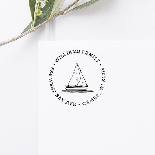 This is a black address labels by Port of Reverie called sailboat return address stamp, round self inking in standard