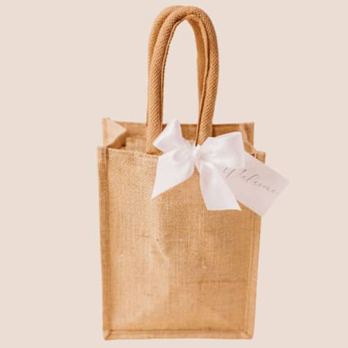This is a multicolor wedding day of favors by Lavender and Pine Gifting called jute gift bag with gift tag and satin ribbon in standard