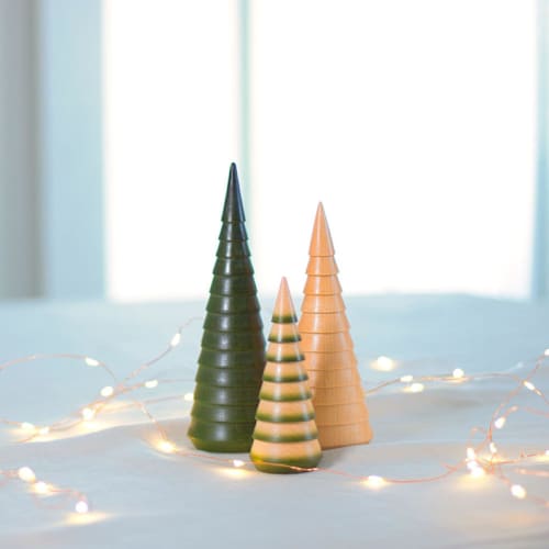 This is a green holiday decorations by Ann Nygard called set of three hand-turned christmas trees in standard