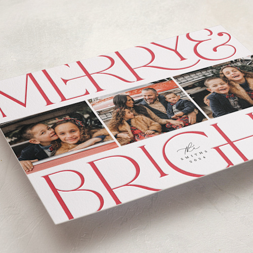 This is a cherry letterpress holiday cards with letterpress by Laura Hamm called merry and bright printing on bright white letterpress paper in standard