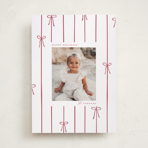 This is a cherry letterpress holiday cards with letterpress by Ellen Schlegelmilch called lines of bows printing on bright white letterpress paper in standard