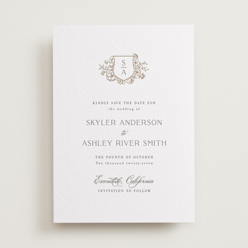 This is a champagne save the date with letterpress by Cass Loh called floral crest printing on somerset500 in standard