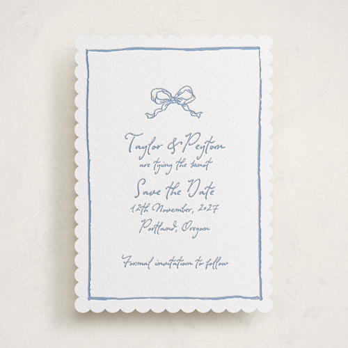 This is a pacific blue save the date with letterpress by Cass Loh called ribbon bow drawing printing on white cotton in standard