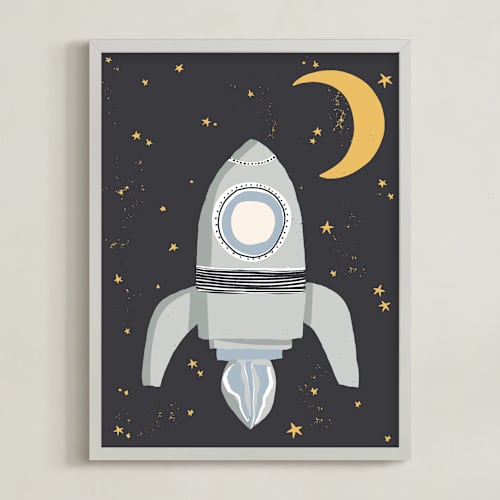 This is a muted blue kids wall art with standard by Maggie Unruh called up in space rocket ship