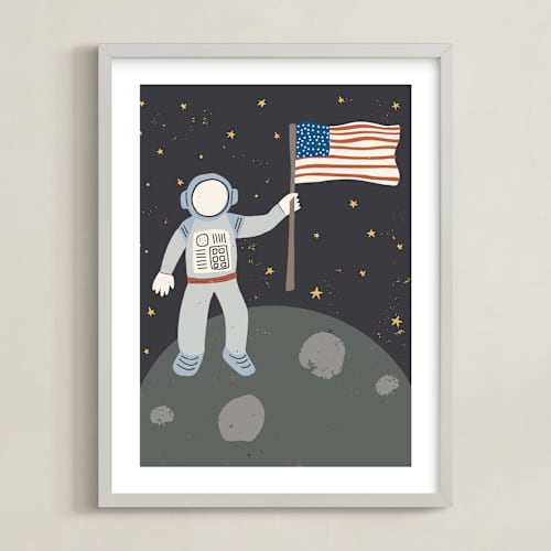 This is a muted blue kids wall art with standard by Maggie Unruh called up in space astronaut