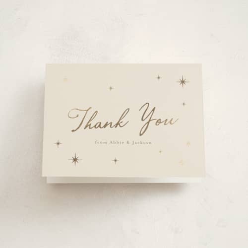This is a linen baby thank you cards with foil pressed by Nicole Walsh called scattered stars printing on strathmore in standard