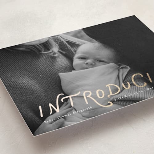 This is a newsprint foil stamped birth announcements with foil pressed by Heather Schertzer called intro printing on recycled smooth signature in standard