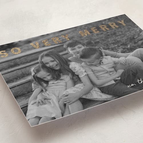 This is a cream foil pressed holiday cards with foil pressed by Jenny Millington called merry greeting printing on recycled smooth signature in standard