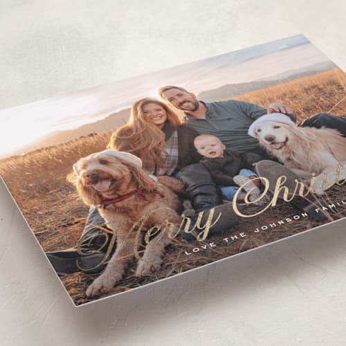 This is a snow foil pressed holiday cards with foil pressed by Rebecca Durflinger called christmas in script printing on recycled smooth signature in standard