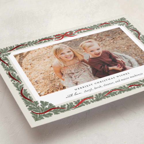 This is a pine foil pressed holiday cards with foil pressed by Paper Raven Co. called merriest ribbon printing on recycled smooth signature in standard