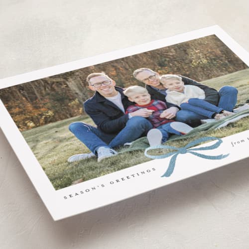 This is a mist foil pressed holiday cards with foil pressed by Olivia Kanaley Inman called crimson bow printing on recycled smooth signature in standard