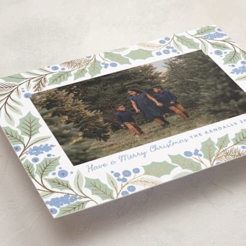 This is a bluebelle foil pressed holiday cards with foil pressed by Kristen Smith called gilded holly border printing on recycled smooth signature in standard