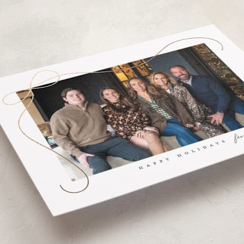 This is a snow foil pressed holiday cards with foil pressed by Lauren Chism called cascading bow printing on recycled smooth signature in standard