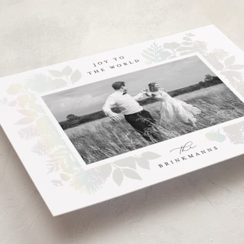 This is a snow gloss press holiday cards with gloss press by Brooke Chandler called joy greenery printing on recycled smooth signature in standard