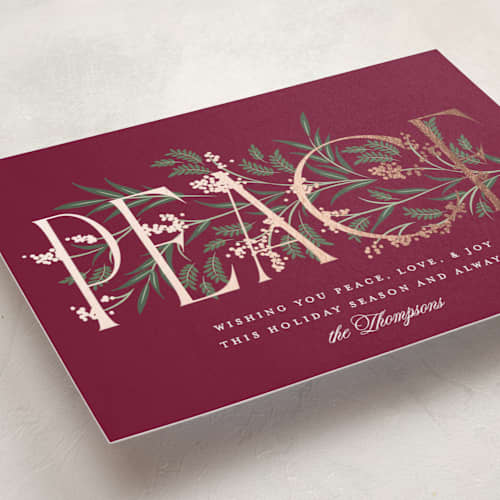 This is a holly berry foil pressed holiday cards with foil pressed by Robert and Stella called entwined peace printing on signature in standard