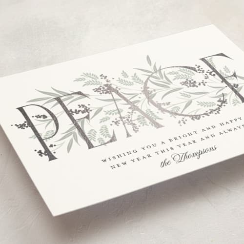 This is a snow foil pressed holiday cards with foil pressed by Robert and Stella called entwined peace printing on signature in standard