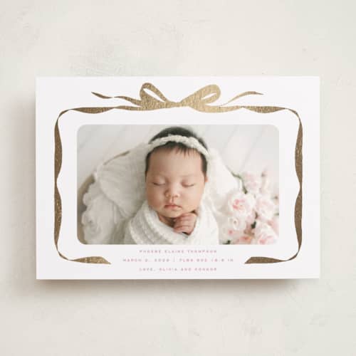 This is a poppy foil stamped birth announcements with foil pressed by Olivia Kanaley Inman called bow printing on recycled smooth signature in standard