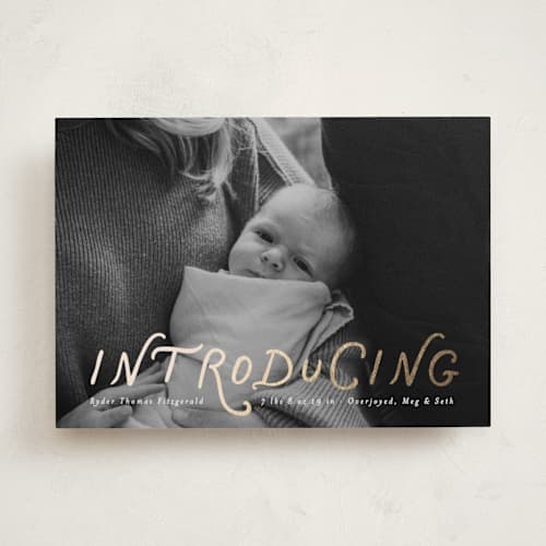 This is a newsprint foil stamped birth announcements with foil pressed by Heather Schertzer called intro printing on recycled smooth signature in standard