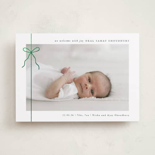 This is a elf shoes babys first christmas with foil pressed by Olivia Raufman called crisp bow printing on recycled smooth signature in standard