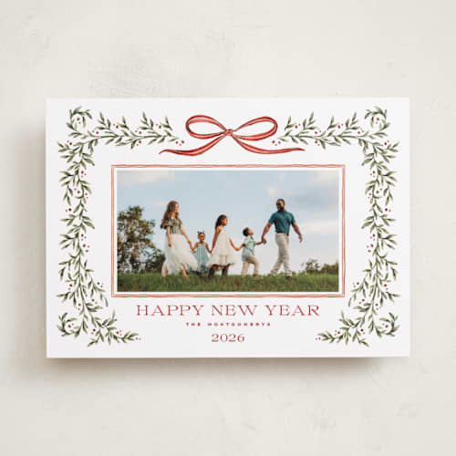 This is a holly berry holiday photo cards with standard by Wildfield Paper Co called laurel wreath printing on recycled smooth signature in standard
