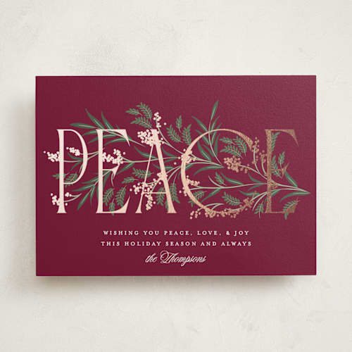This is a holly berry foil pressed holiday cards with foil pressed by Robert and Stella called entwined peace printing on signature in standard