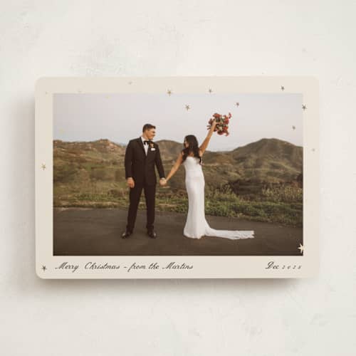 This is a cream foil pressed holiday cards with foil pressed by Ani Somi called star dust printing on recycled smooth signature in standard