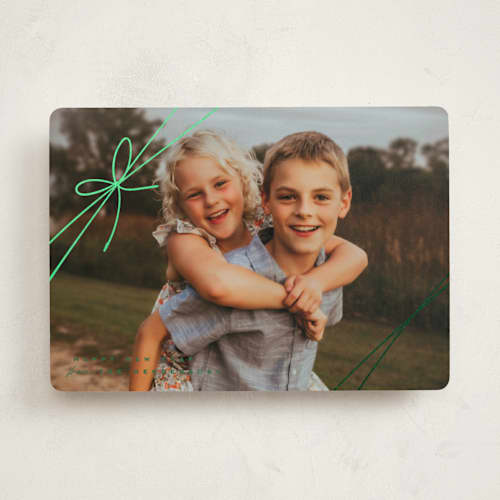 This is a juniper foil pressed holiday cards with foil pressed by Leia Matt called tied with joy printing on recycled smooth signature in standard