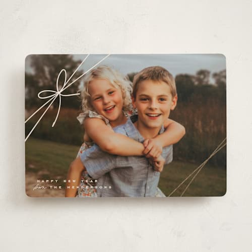 This is a woolen foil pressed holiday cards with foil pressed by Leia Matt called tied with joy printing on recycled smooth signature in standard