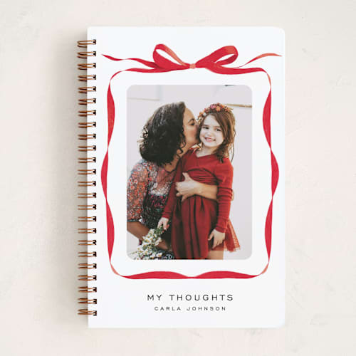 This is a crimson journals with standard by Olivia Kanaley Inman called bow printing on premium cover stock in notebook